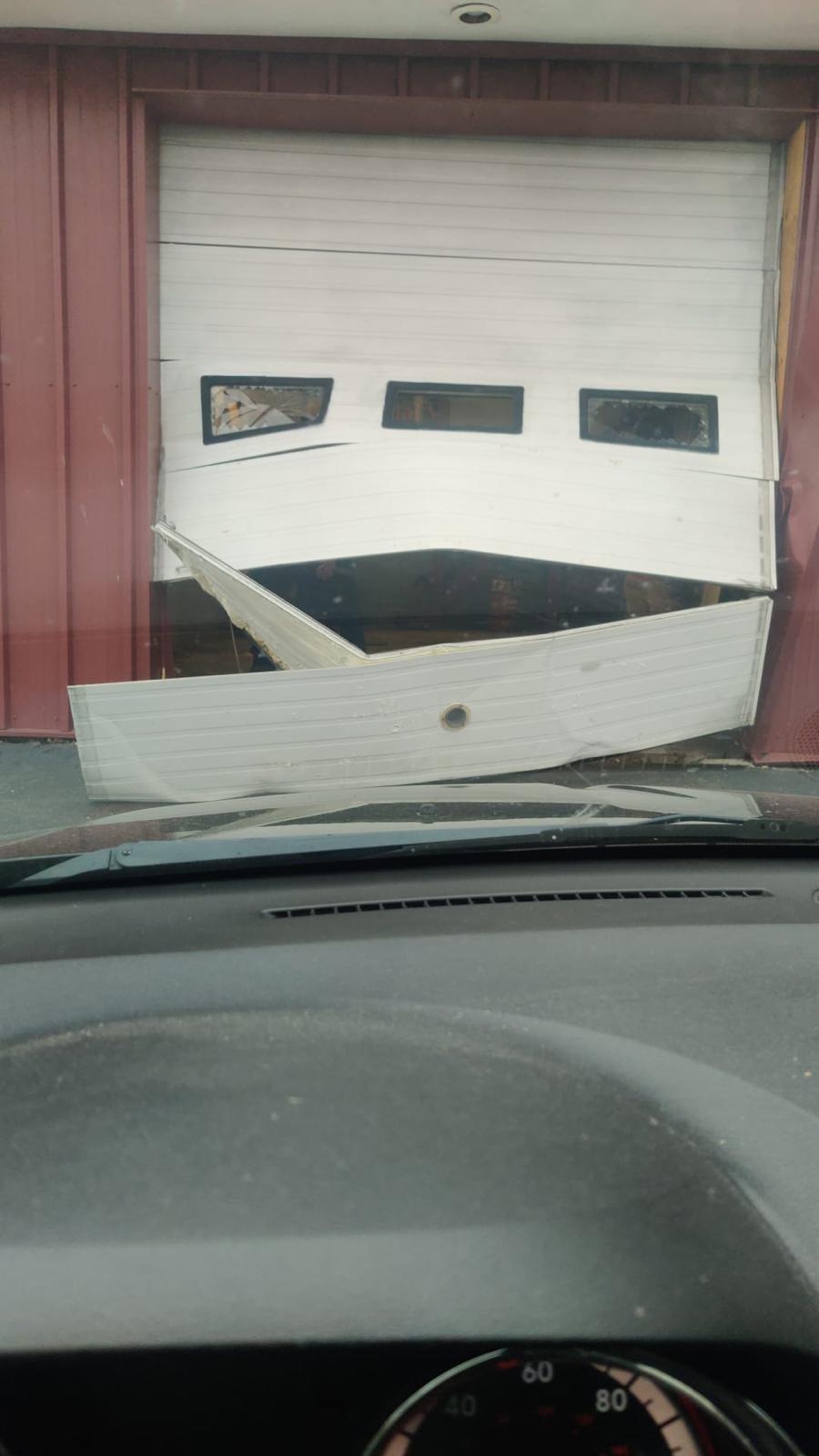 Severely damaged garage door — emergency repair job